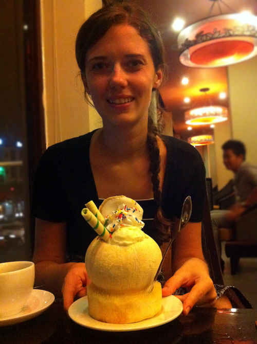 Regina enjoying some delicious coconut icecream in a carved-out coconut in Vietnam