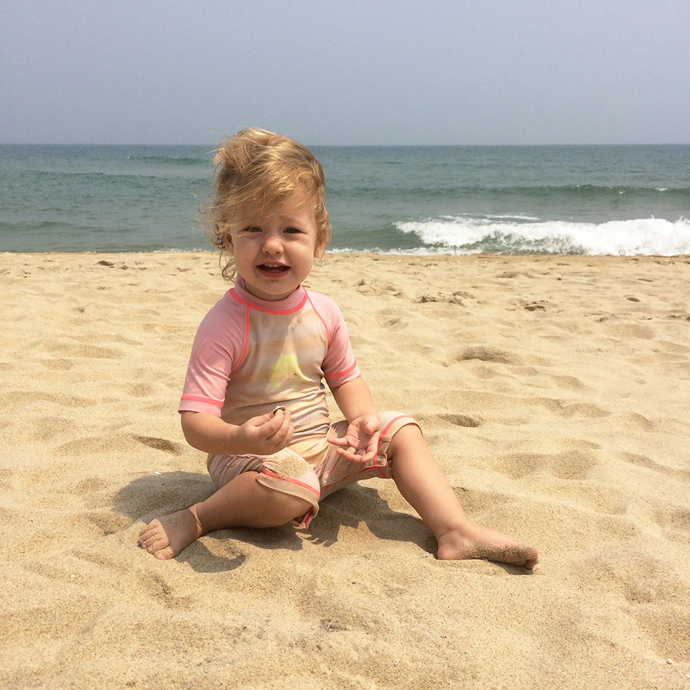 Olivia enjoying the white sand at An Bang Beach