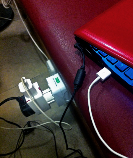 Two adapters in one outlet charging three devices